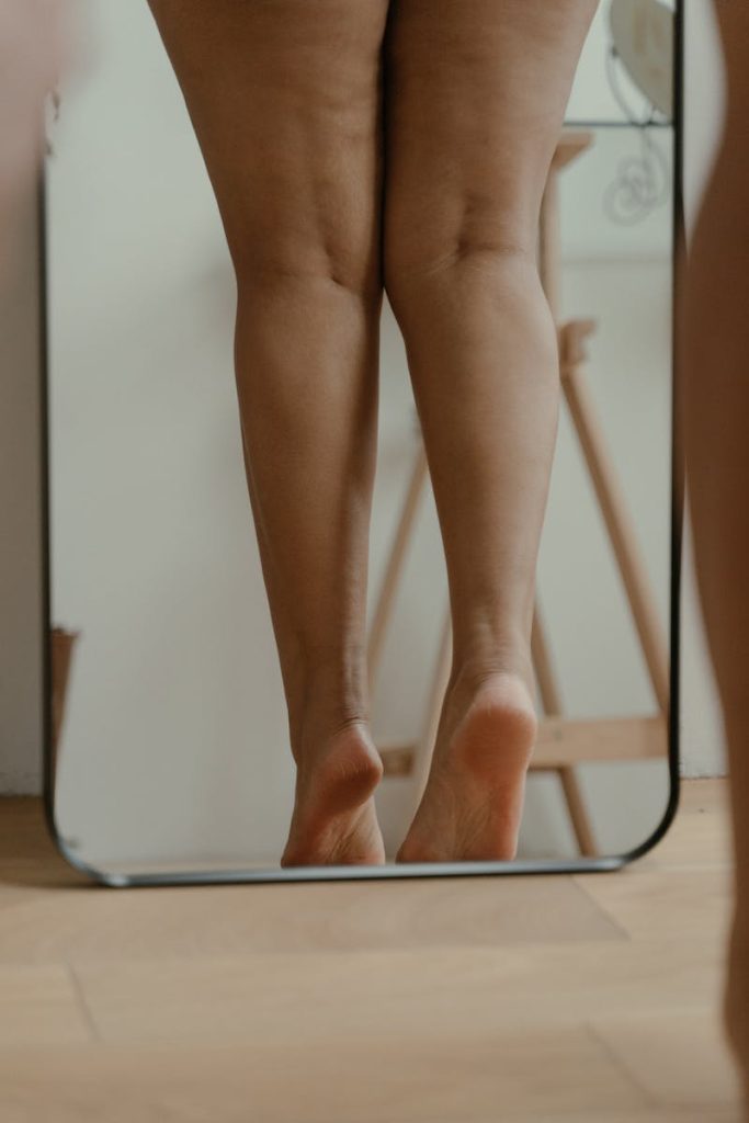 Photo of a Woman's Legs on a Mirror